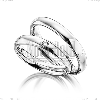 Платиновые обручальные кольца бублики с бриллиантом в женском кольце