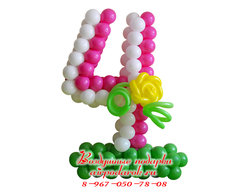 Бело-розовая цифра 4 на зеленой полянке из шаров с яркой желтой розой