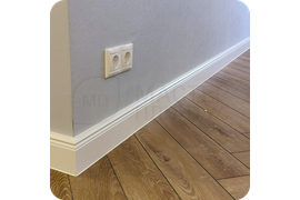 Престижный интерьер: установка белого плинтуса Dollken Hamburg Style 80 создает атмосферу престижа и утонченного вкуса, подчеркивая статусность пространства.