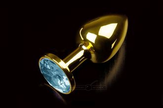 Маленькая золотистая анальная пробка с круглым кончиком и голубым кристаллом - 7 см