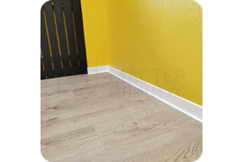 Свежий акцент: установка белоснежного плинтуса Dollken S60 - идеальное решение для создания светлого, воздушного интерьера с безупречной чистотой цвета.