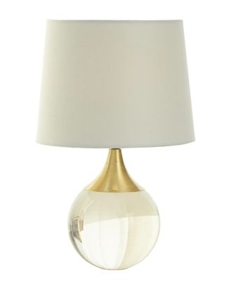 Настольная лампа в форме хрустального полированного шара с латунью и белым абажуром.