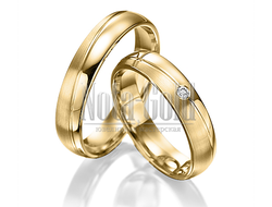 Классические обручальные кольца бублики из жёлтого золота с ассиметричной дорожкой с бриллиантом в ж