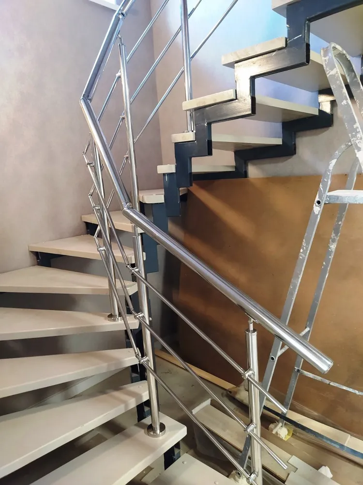 перила из нержавеющей стали на лестнице с забежными ступенями