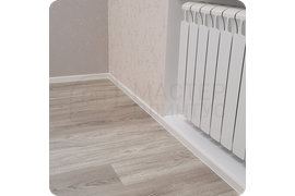 Визуальная гармония: монтаж белого плинтуса Dollken Cubu Flex Life 40 обеспечивает безупречное сочетание с любым интерьером, создавая эффектный завершающий штрих.