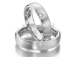 Матовые обручальные кольца из белого золота с бриллиантом у края женского кольца