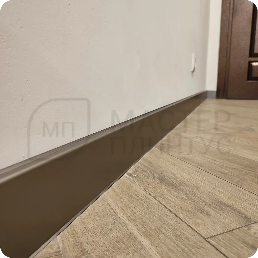 Изысканное обрамление: установка бронзового плинтуса создает утонченное обрамление пространства с теплым металлическим сиянием.