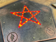 Table with pentagram and cards