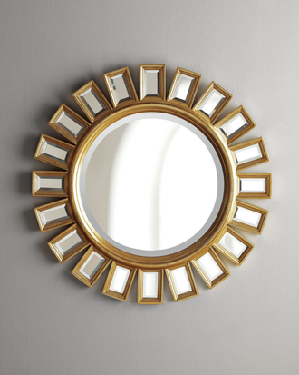Зеркало солнце в золотой раме в виде прямоугольных зеркальных элементов.
