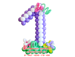 Цифра один, плетеная из бело-фиолетовых шаров, стоящая на полянке