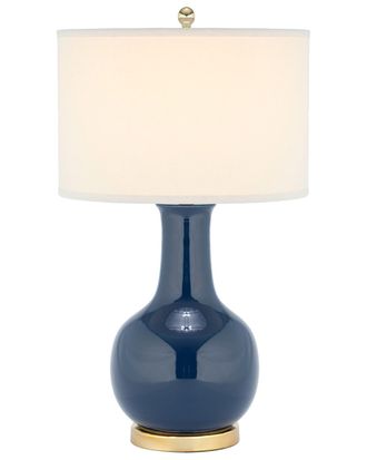 Настольная лампа из синей керамики с белым абажуром.