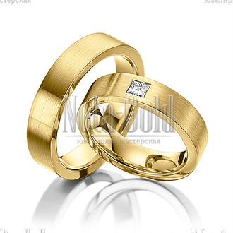 Классические обручальные кольца из желтого золота с крупным бриллиантом в женском кольце прямоугольн