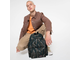 Парень держит в руках рюкзак Eastpak Padded Pak'r Leaves Dark