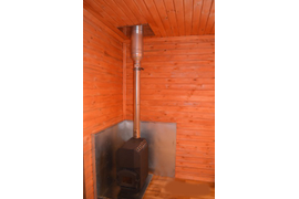 Печь на фундаменте, во круг печки термостойкая сэндвич панель.